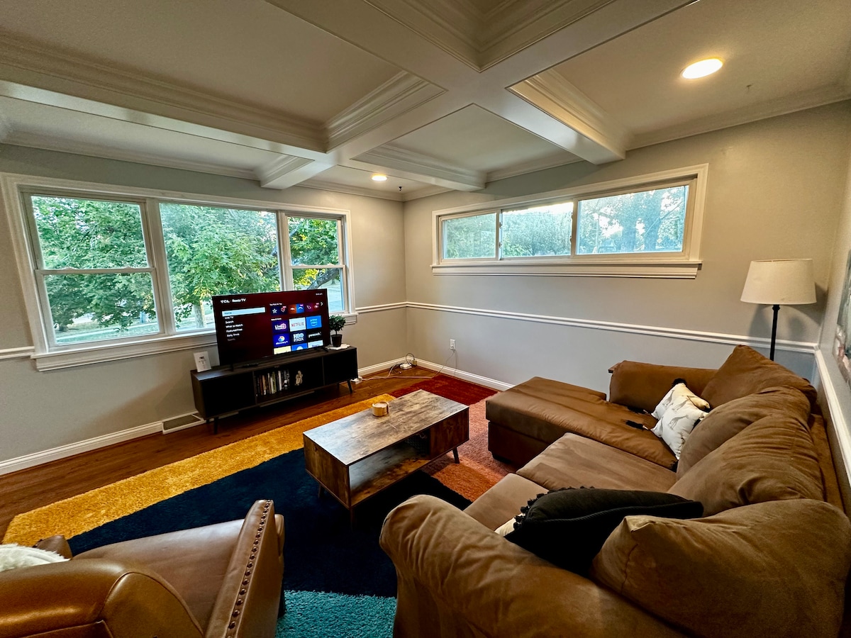 Woonkamer met smart-tv met uitzicht op de voortuin.