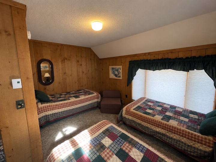 Two twin beds plus a trundle bed, comfortably sleeping up to four guests.