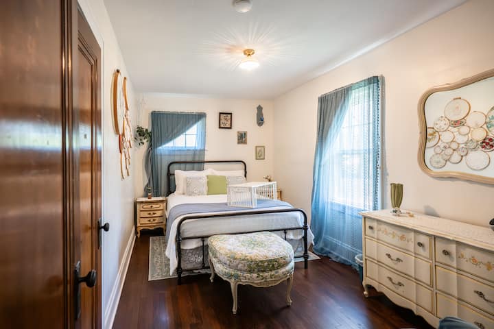 Comfy queen sized bed with boho vibes! Blackout curtains and noise machine/alarm clock help you to have a great night's sleep!