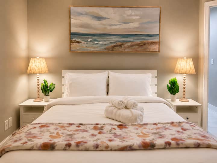 ~ Unwind in a cozy queen bed dressed in soft linens—perfect for restful nights after a day of beachside adventures.