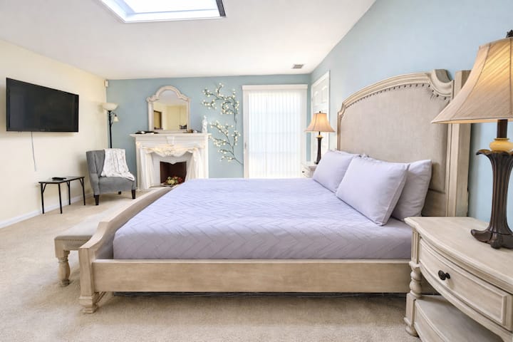 - Stylish bedroom with king bed and cozy fireplace  
- Calm blue tones and soft natural light throughout  
- Romantic space for peaceful nights and mornings  

