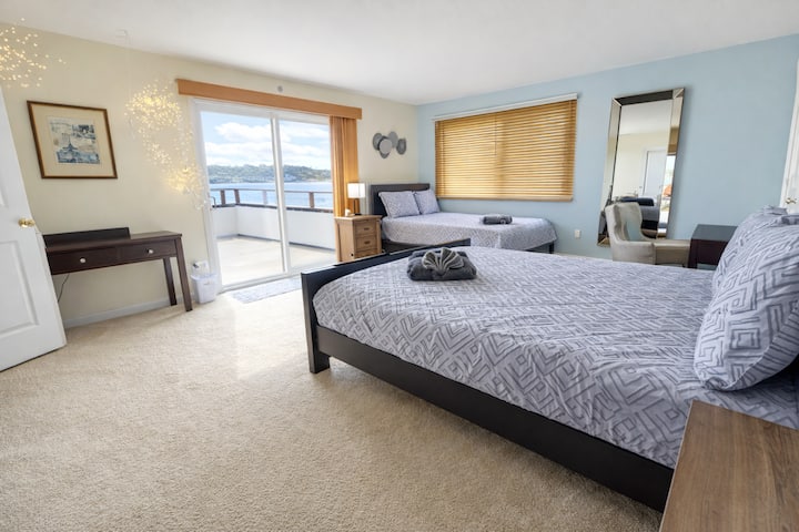 - Cozy bedroom with balcony access and sunlight  
- Extra seating and desk for comfort and work  
- Ideal coastal getaway with refreshing ambiance  
