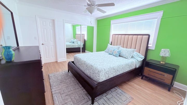 Patterned pillows & pops of color — Rest, reflect, and recharge in this artful bedroom escape. Queen Bed with comfortable pillows, side table and chest and mirror set.
