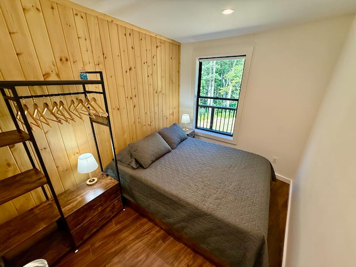 Main level Bedroom 3: Queen size bed, night stands with USB and 110v outlets, lamps, wardrobe, hangers, ear plugs - Front Royal Yurt