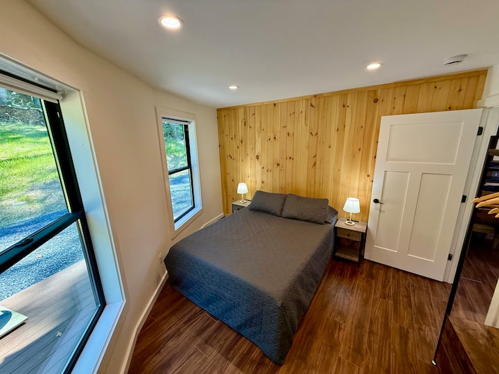 Main level Bedroom 2: Queen size bed, night stands with USB and 110v outlets, lamps, wardrobe, hangers, ear plugs - Front Royal Yurt