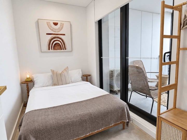 A welcoming second bedroom with direct access to the enclosed balcony