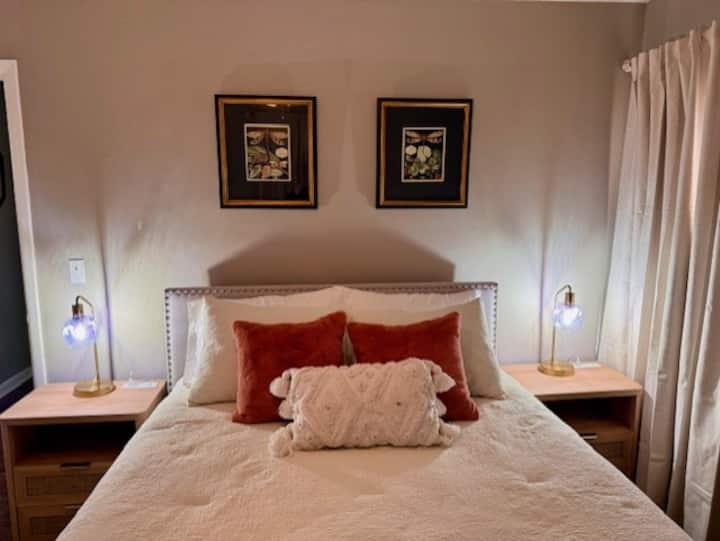 Queen bed with new mattress + soft linens + pillows - Blackout curtains + cellular blinds - Closet - Ceiling fan - Nightstands - Touch lamps - Luggage rack - USB ports - Chair + throw blanket - Thoughtful accents - Hardwood floors - Soft area rug