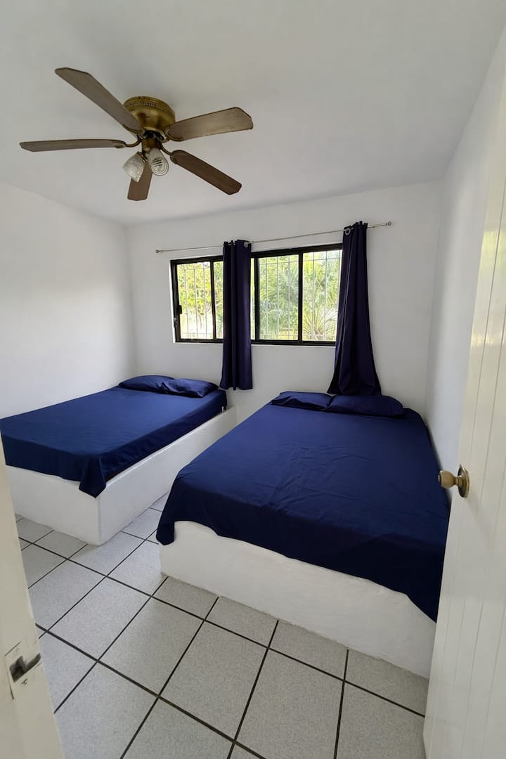 Room #2
With two double beds, a ceiling fan, a large closet and a small vanity.