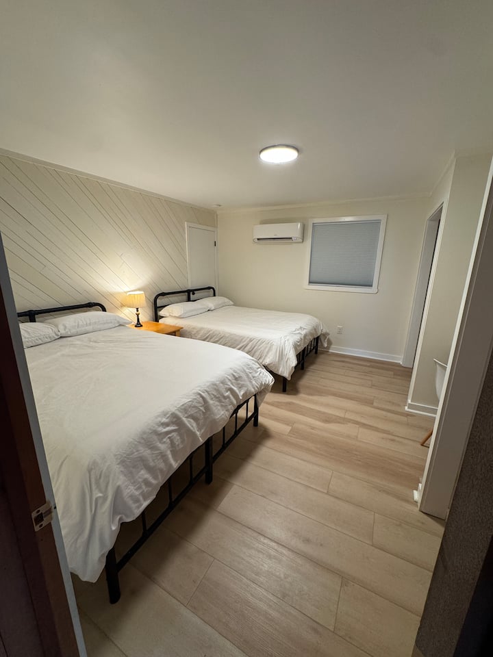 The downstairs bedroom includes 2 queen beds.