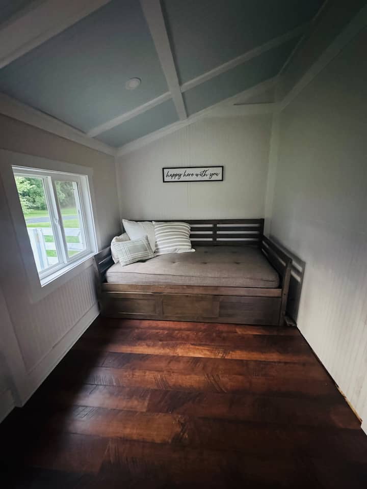 Krevet na razvlačenje u prostoriji ispunjenoj suncem u kojoj mogu spavati 2 osobe