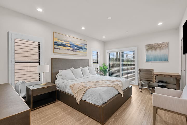 Master bedroom with cal king bed and desk.