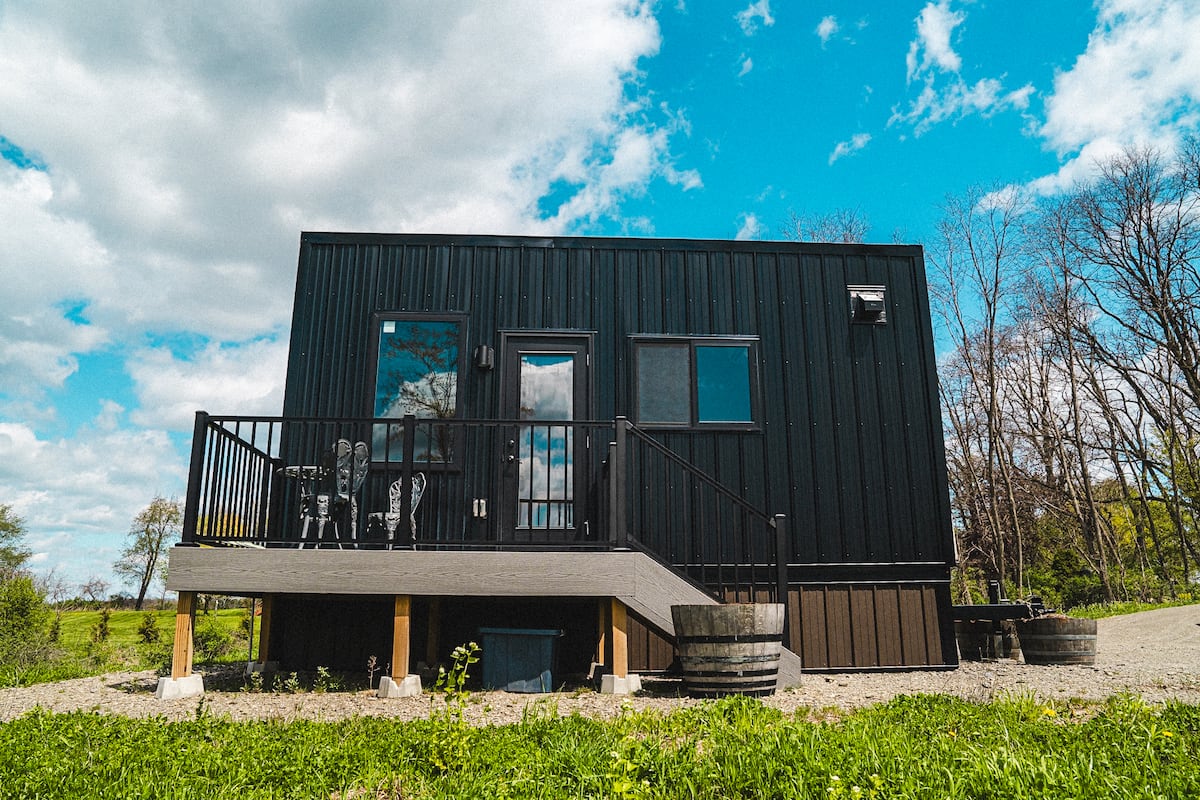 The Serene, a modern tiny container home at Osmote overlooking the vineyard and Seneca Lake
