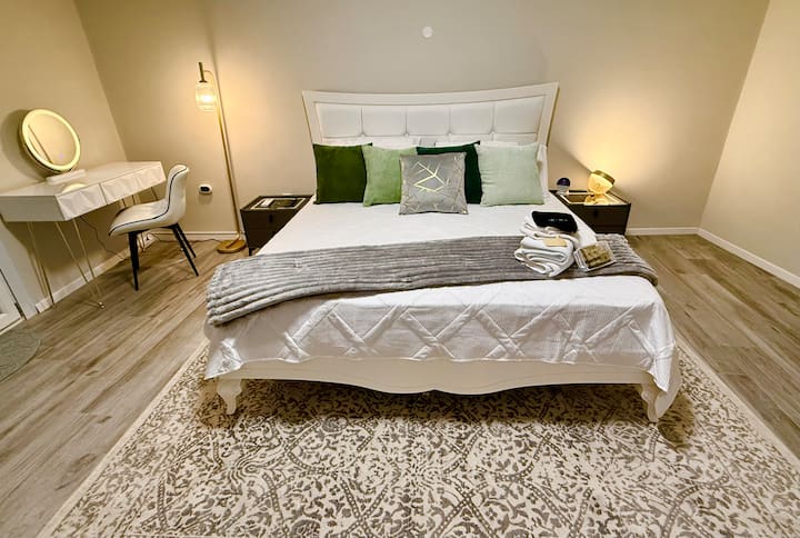 Kingsized Bed, assortment of sleeping pillows, wireless and wired charging station nightstands. Smart speaker assistant, Hue lighting and smart TV. 