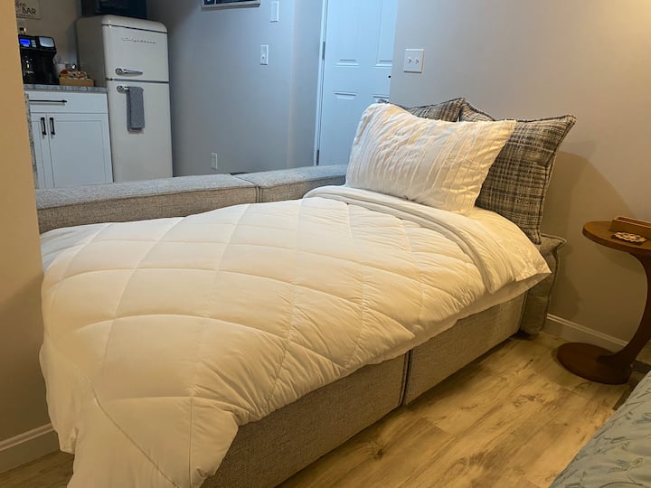 El sofá se convierte en una cómoda cama doble. Retira los cojines traseros y usa la ropa de cama ubicada en el armario.