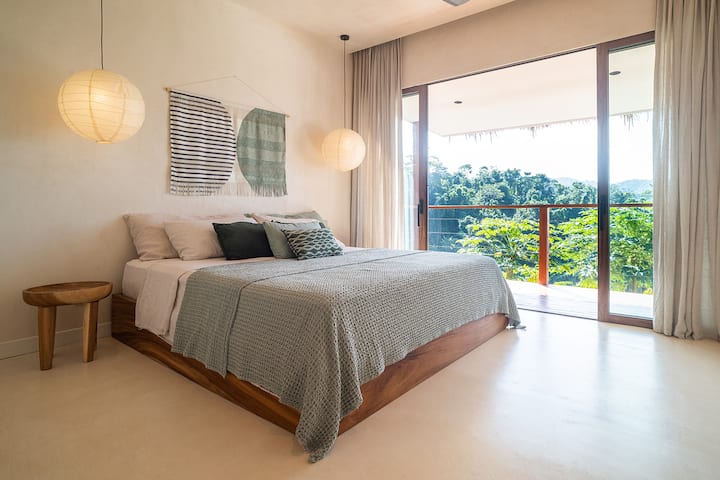 King sized bed with private terrace overlooking private jungle valley and stream.