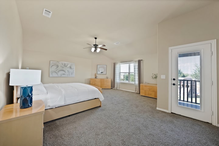 2nd Master Suite: Sun-kissed elegance with plush carpet and serene views just steps away!