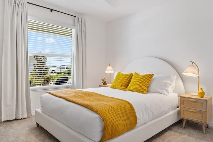 Queen bed featuring a luxurious mattress, soft bedding, feather-light duvet, and plenty of pillows for your comfort.
