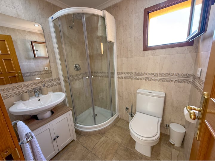 Baño de la primera planta con ducha y ventana: cómodo y ventilado.