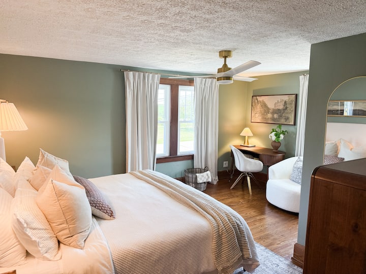 This Bedroom features a King sized bed, Walk-in closet, a Desk & a swivel chair