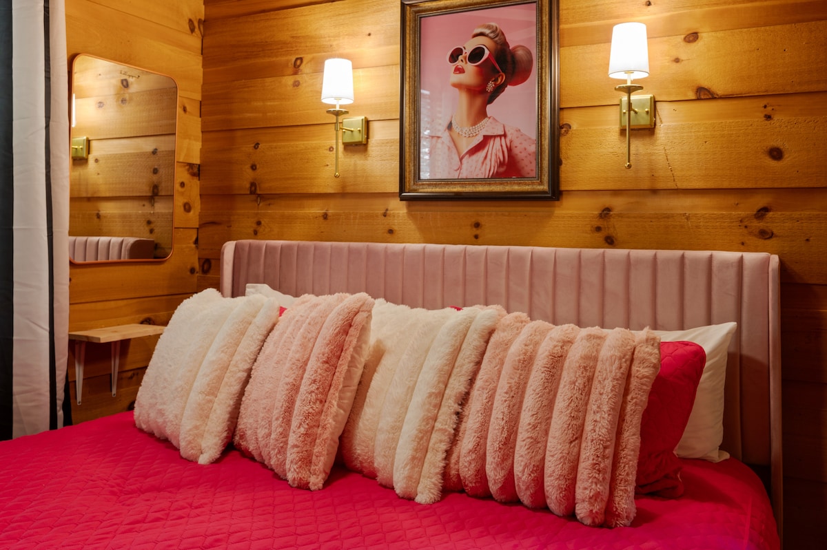 Táto príjemná spálňa kombinuje rustikálne kúzlo s útulnou eleganciou. Nachádza sa v nej luxusná manželská posteľ s čerstvou bielou bielizňou a mäkkými vankúšmi. Veľké okno ponúka pokojný výhľad na stromy hneď za oknom.