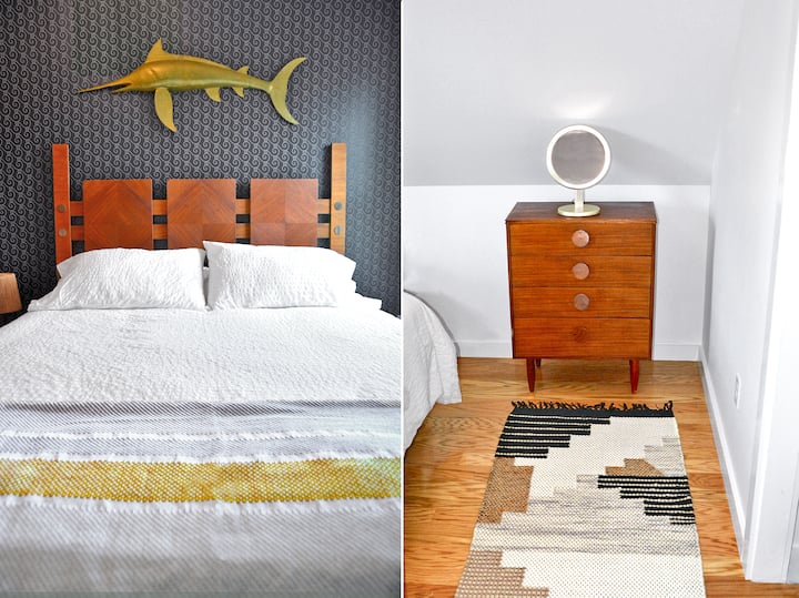 Guest bed with distinctive headboard, brass swordfish, and teak dresser.