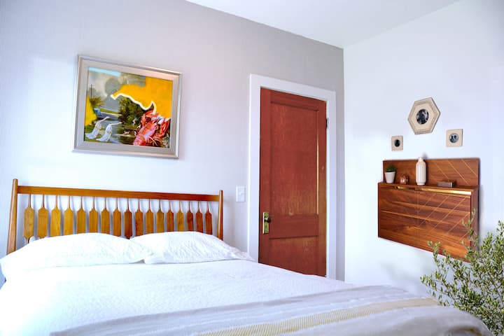 Primary bedroom with Kipp Stewart headboard and stylish, drop down desk. (Wifi available.)