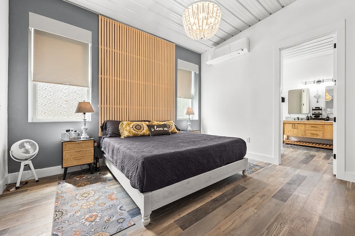 The master bedroom boasts a king-sized bed and beautiful view of the back of the property! It has its own climate control and full bath with soaking tub, dual vanities,  and two-person shower.