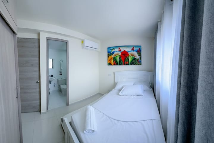 Room with private bathroom, double bed + trundle bed, translucent white curtains + black out gray curtains, air conditioning, LED lights, large closet.