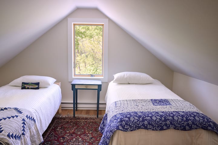 Spavaća soba s dva odvojena kreveta na katu nudi mekanu posteljinu i mirnu atmosferu, a kada je potrebno, televizor je u susjednoj sobi. 