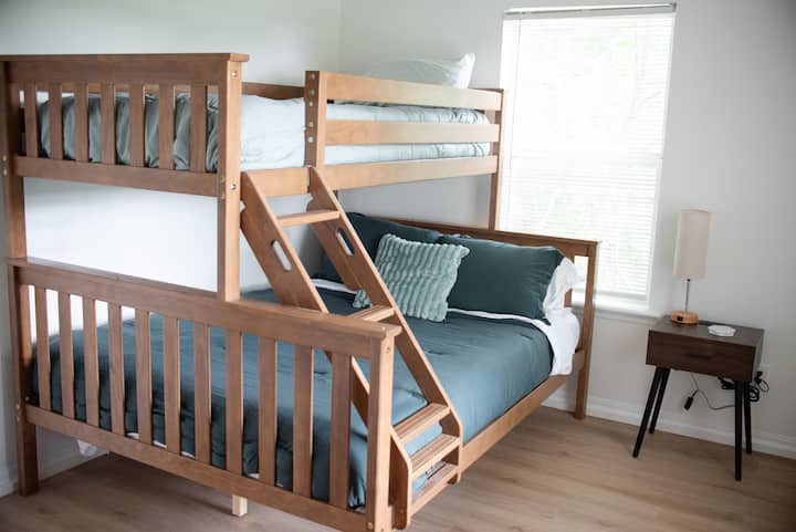 Whether it’s kids, teens, or extra adults, this bunk room offers a perfect mix of comfort and space. The frame holds a queen bed below and a twin above. Fresh, cozy linens. simple décor and reading lamp make it a peaceful place to enjoy the Ozarks.