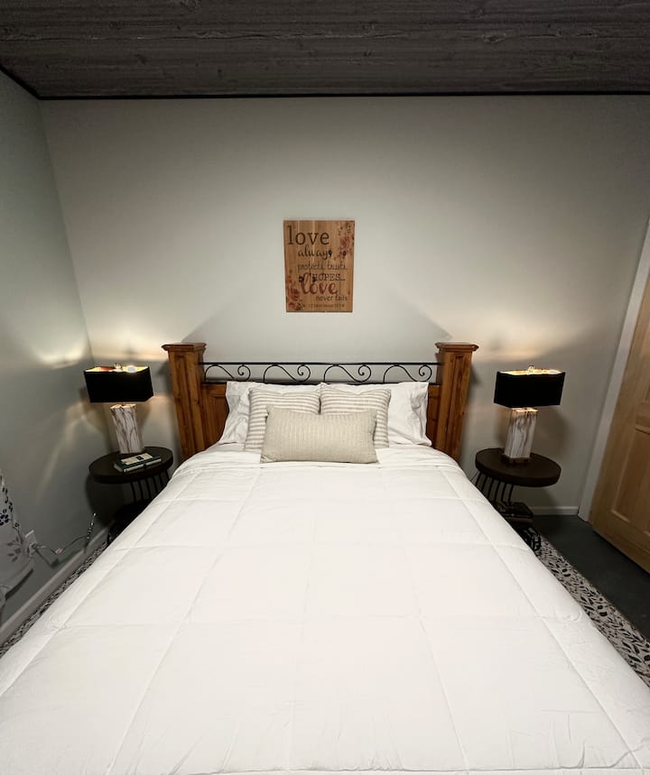 This bedroom downstairs has a full body size mirror (not in picture) and a closet with a barn door. This room also has 2 luggage racks for your use.