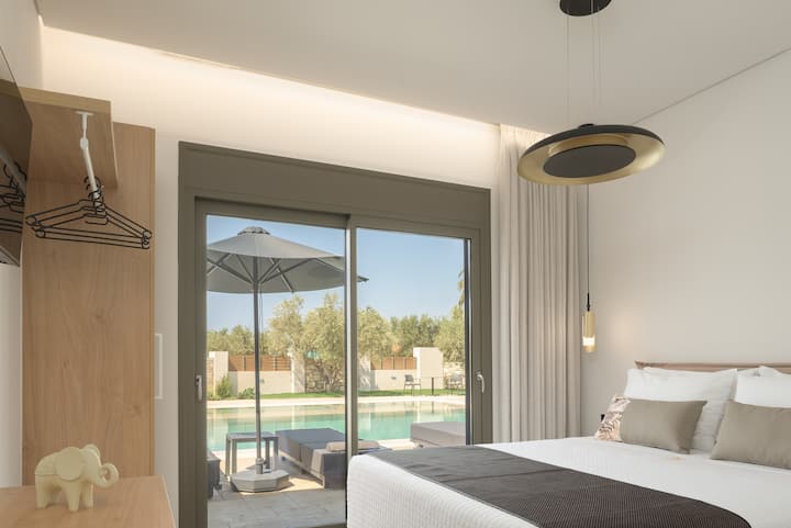 Luminosa camera da letto matrimoniale con accesso diretto alla piscina all'aperto.
