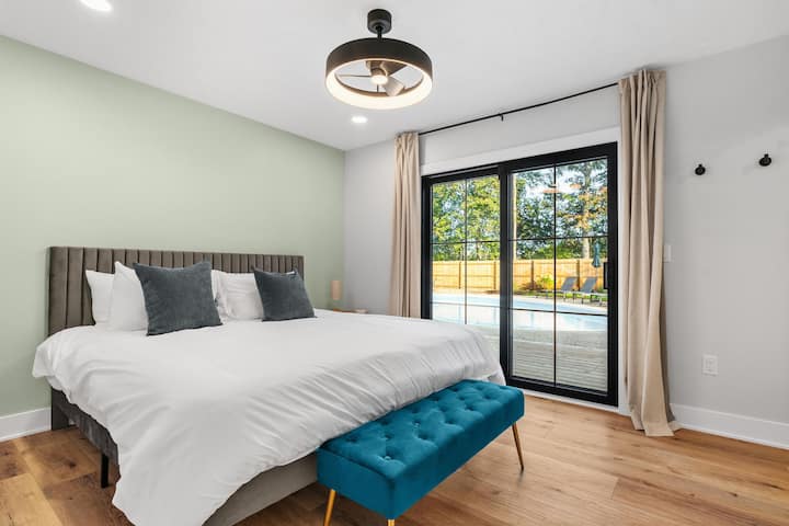 Primary King suite with private en-suite bath and direct access to the deck, backyard and pool.