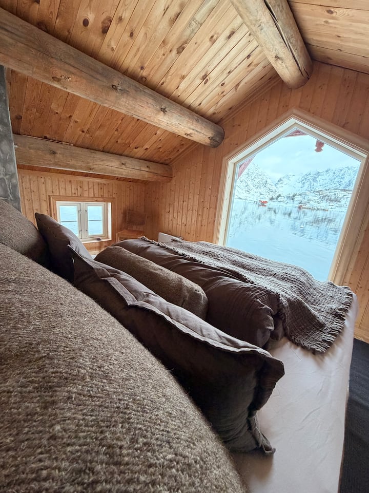 Hovedsoverom etter oppussing med stort vindu foran. Rullegardiner er montert for solbeskyttelse.