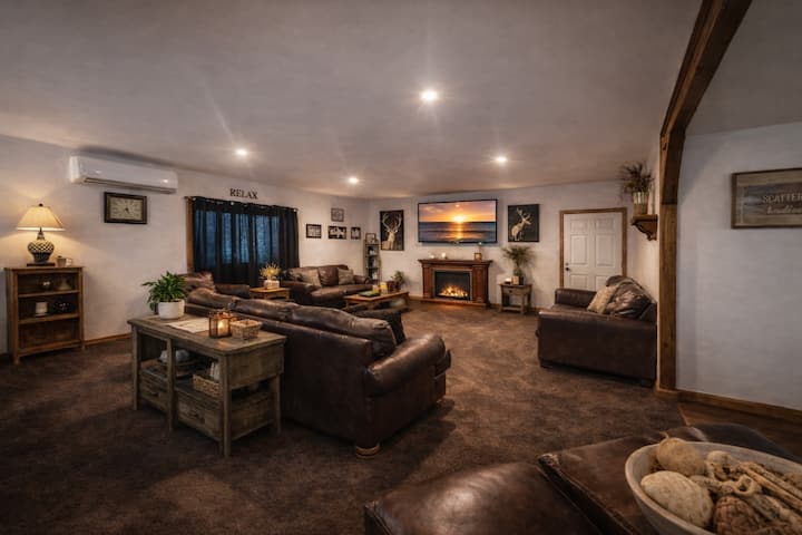 Spacious, cozy great room designed for connection and comfort. This inviting living area features a rounded, open layout with plush leather seating for 10+ guests, perfect for gathering, relaxing, and spending time together.