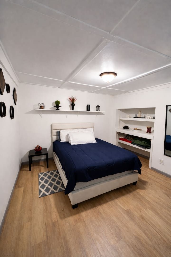 Bedroom 2 – The Cozy Queen: A comfortable queen bed with a Roku TV so you can relax and stream your favorite shows after a day of exploring.