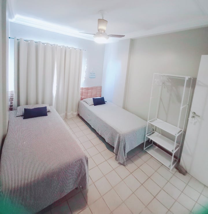 2 camas individuales, ventilador de techo, vista al mar y un pequeño perchero para acomodar la ropa.