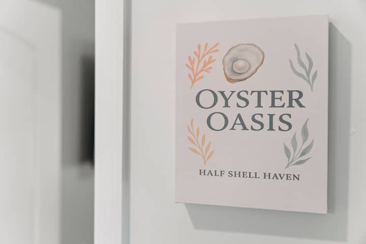 Our “Oyster Oasis” bedroom offers a spacious king bed, cozy seating, and a smart TV, creating a comfortable retreat to relax, watch a favorite show, or recharge after long beach days.
