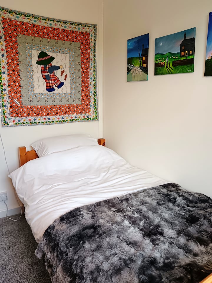 A comfortable single bedded room with wardrobe and small desk. This room is located at the rear of the cottage.
