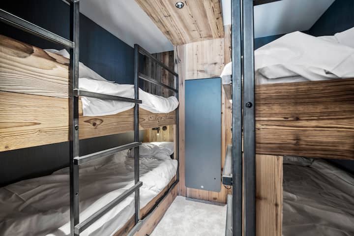 غرفة نوم مع سريرين بطابقين مخصصين مع قارئ إلكتروني لكل سرير
لاحظ أن غرفة النوم هذه لا تحتوي على نافذة (ولكن باب زجاجي إلى غرفة المعيشة)