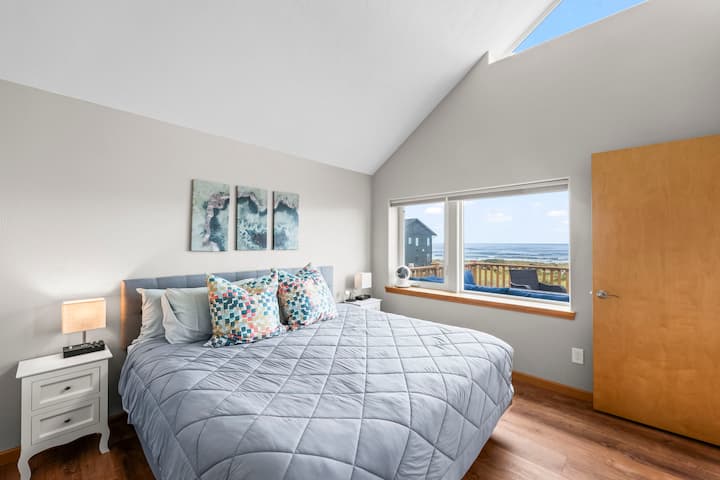 Have a glimpse of the ocean from the main bedroom while enjoying the comfort of this king-sized bed.