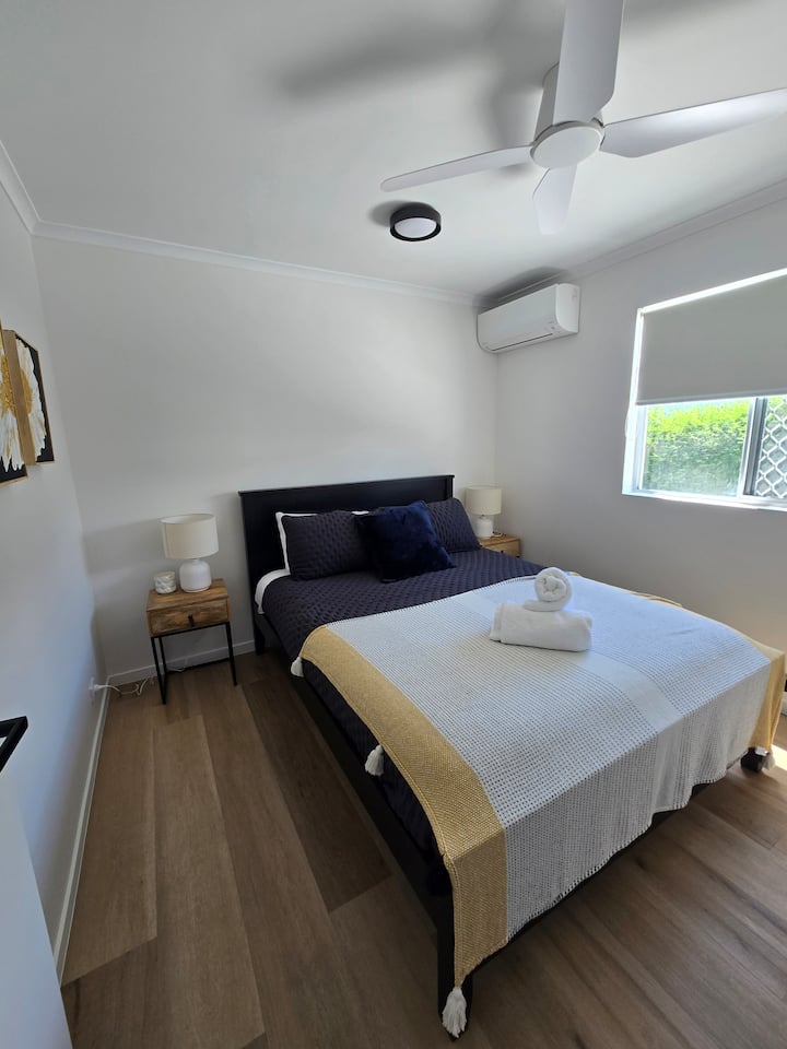 标准双人床，配备风扇和空调、衣柜