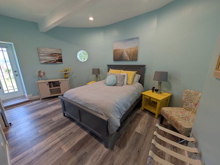 3rd floor private queen size bedroom with attached bath, portable fan, and balcony.