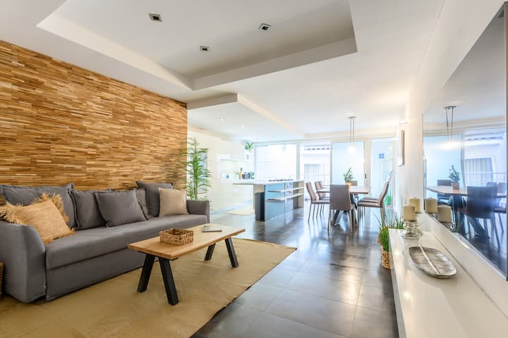 Elegante apartamento en Sliema con un luminoso salón, una pared de madera y un televisor inteligente de 75". Diseño moderno y confort refinado, a pocos pasos del mar, restaurantes y tiendas. Perfecto para parejas, familias y viajeros.