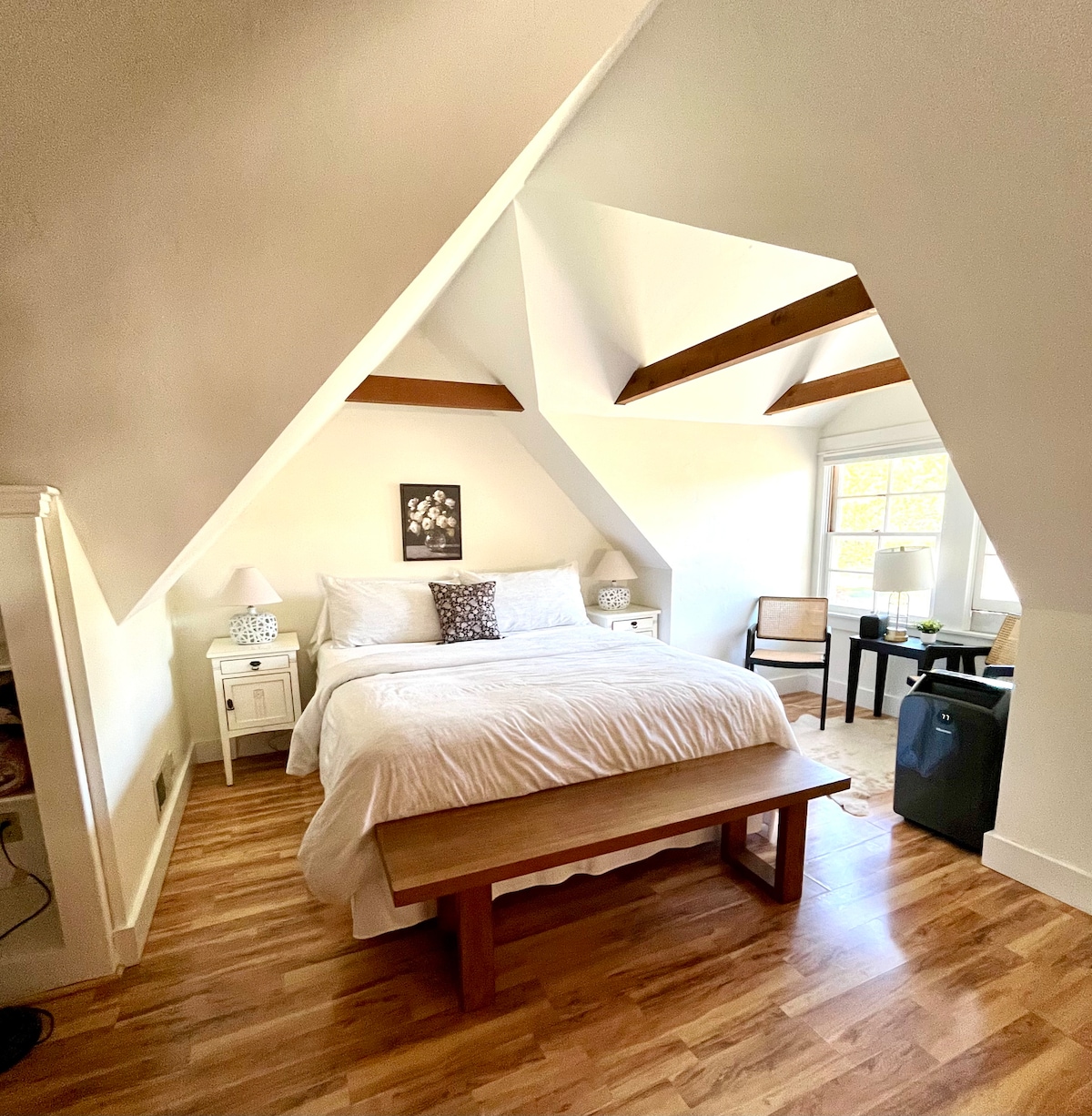 The entire 2nd floor is yours to enjoy in the primary suite . Includes a Cal King bed with generous duvet and adjacent sitting area. Wonderful beams and dormer angles highlight the farmhouse architecture. 