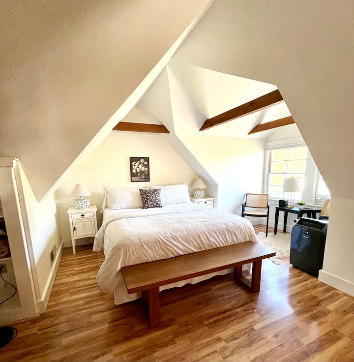 The entire 2nd floor is yours to enjoy in the primary suite . Includes a Cal King bed with generous duvet and adjacent sitting area. Wonderful beams and dormer angles highlight the farmhouse architecture. 