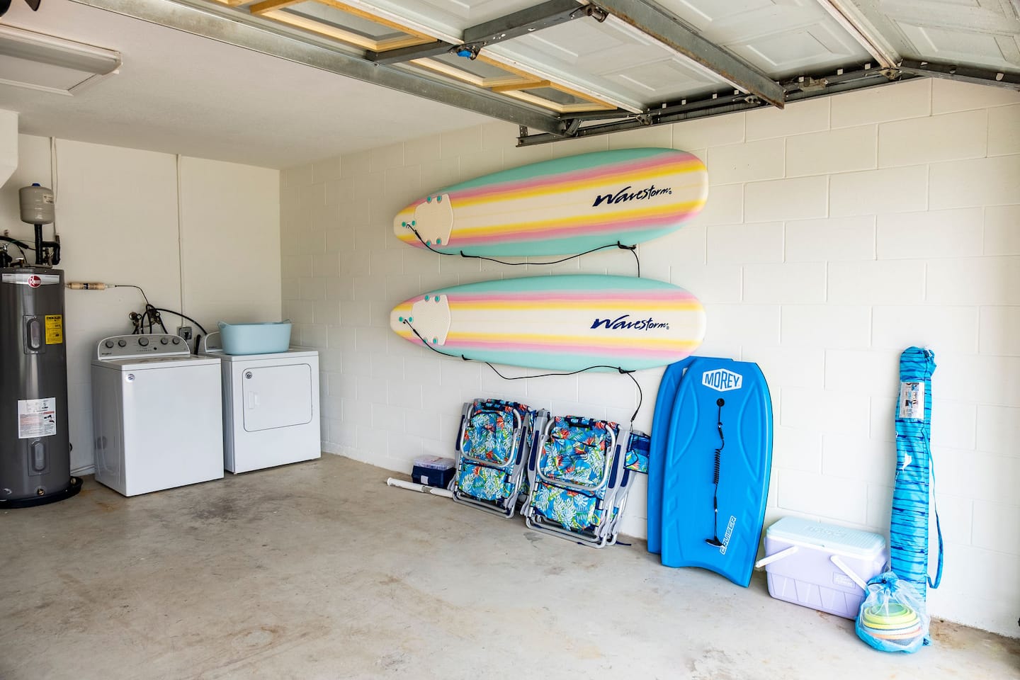 Garage laundry area with surfboards and boogie boards, Luxury Beach Haven, Palm Coast, Florida