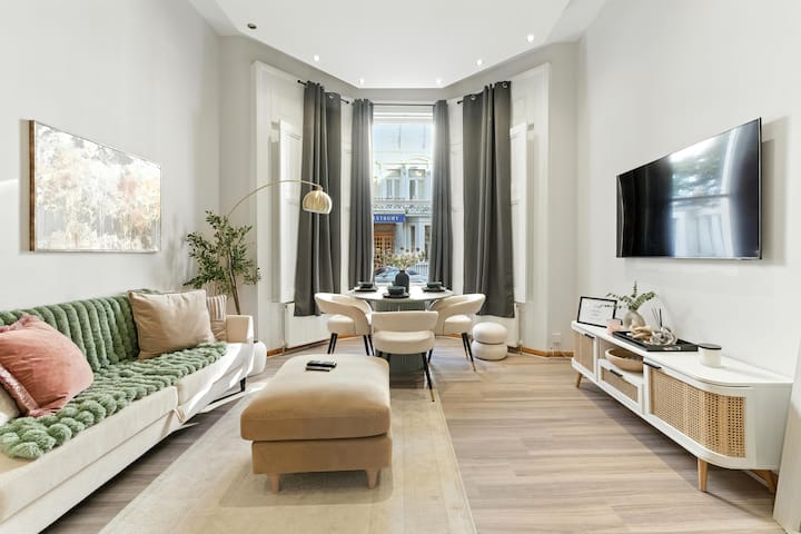 סלון מואר ומסוגנן עם עיצוב שיקי, חלונות גדולים ופינת אוכל נעימה - שילוב מושלם של נוחות ואלגנטיות במרכז לונדון!