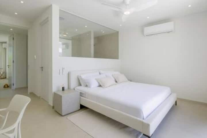 Well appointed bedroom 2 has a US king size bed, stunning sea views, air conditioning, ceiling fan and a fabulous en suite shower room with rain shower head and countertop basin.