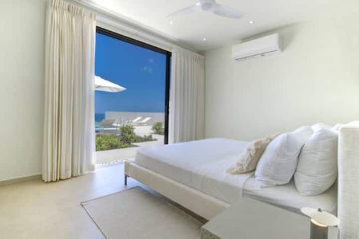 Well appointed bedroom 3 has a Twin / US king size bed, stunning sea views, air conditioning, ceiling fan and a fabulous en suite shower room with rain shower head and countertop basin.